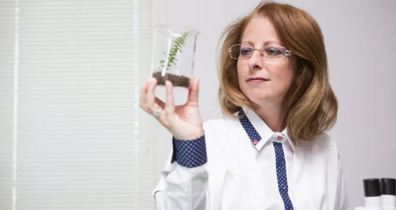 Medical marijuana doctor in a white coat at her desk, ready to consult Rhode Island patients